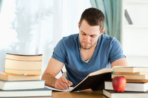 Male student working through his books-1