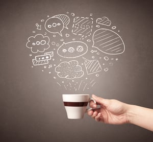 Young female hand holding coffee cup with drawn thought bubbles above it